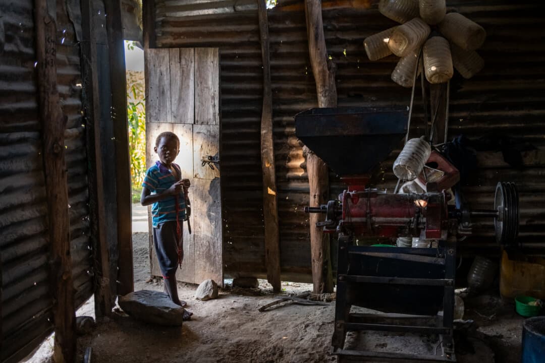 A boy walks into a grain mill in the Blantyre Rural District of Malawi on Feb. 23, 2026. (John Fredricks/The Epoch Times)