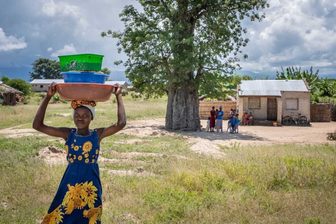 A young woman walks along a road in the Machinga District of Malawi on Feb. 22, 2026. (John Fredricks/The Epoch Times)