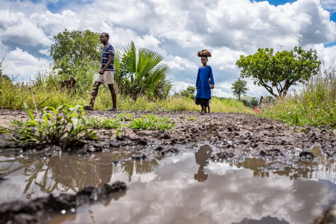 People navigate flooded roads outside of Monkey Bay, Malawi, on Feb. 18, 2026. (John Fredricks/The Epoch Times)