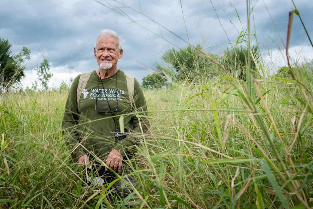 Water Wells for Africa founder Kurt Dahlin treks through rural farmland outside of Monkey Bay, Malawi, on Feb. 18, 2026. (John Fredricks/The Epoch Times)