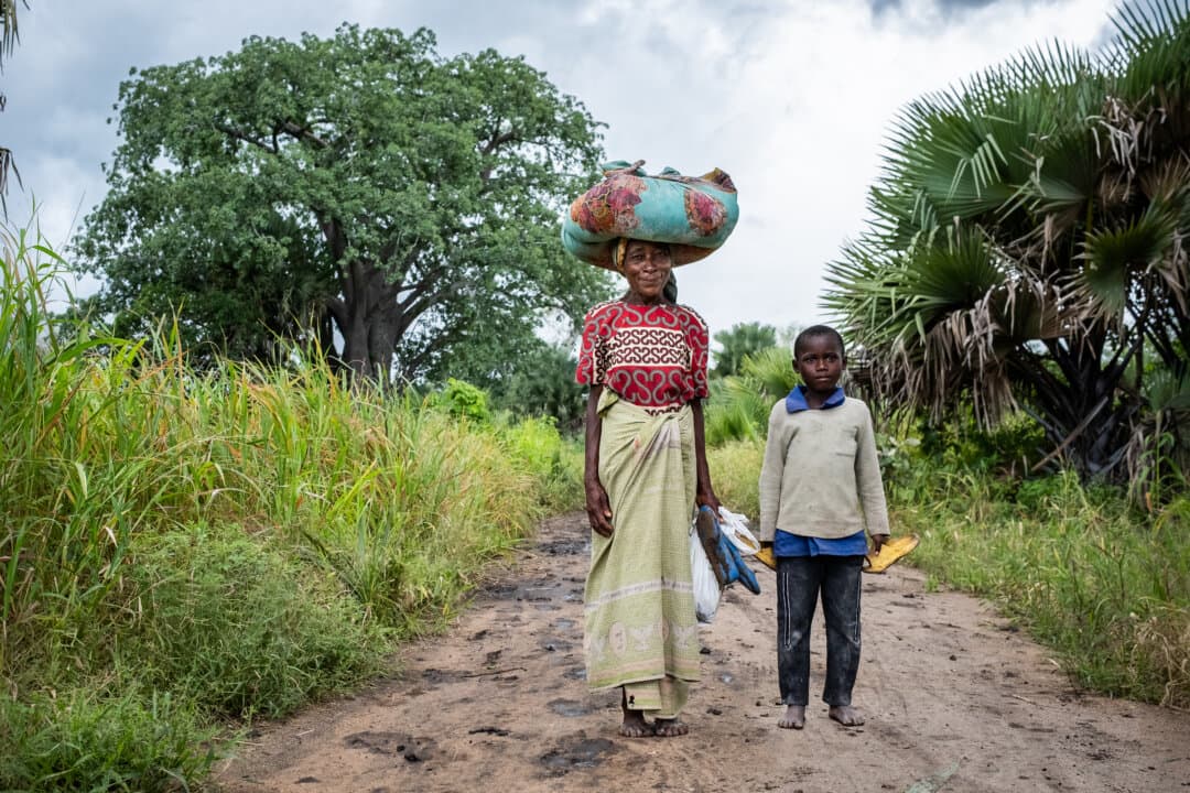 A mother and son walk down a road outside of Monkey Bay, Malawi, on Feb. 18, 2026. (John Fredricks/The Epoch Times)