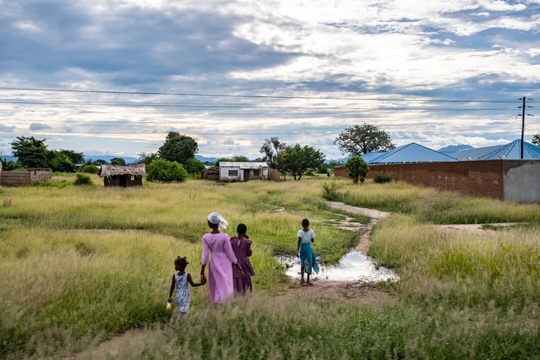 People walk on a roadway outside of Blantyre, Malawi, on Feb. 17, 2026. (John Fredricks/The Epoch Times)