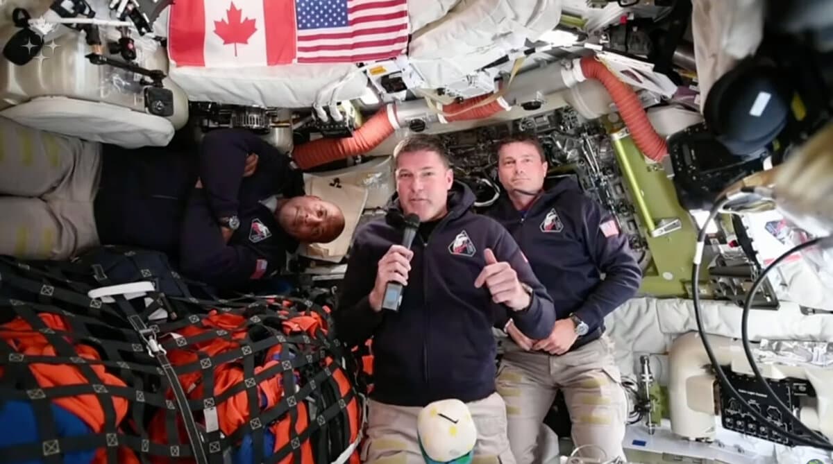 Artemis II astronaut Jeremy Hansen, of Canada, connects live from the Orion spacecraft and speaks with Canadian media along with NASA astronauts Victor Glover (L) and Reid Wiseman on April 4, 2026. (The Canadian Press/AP/Canadian Space Agency)