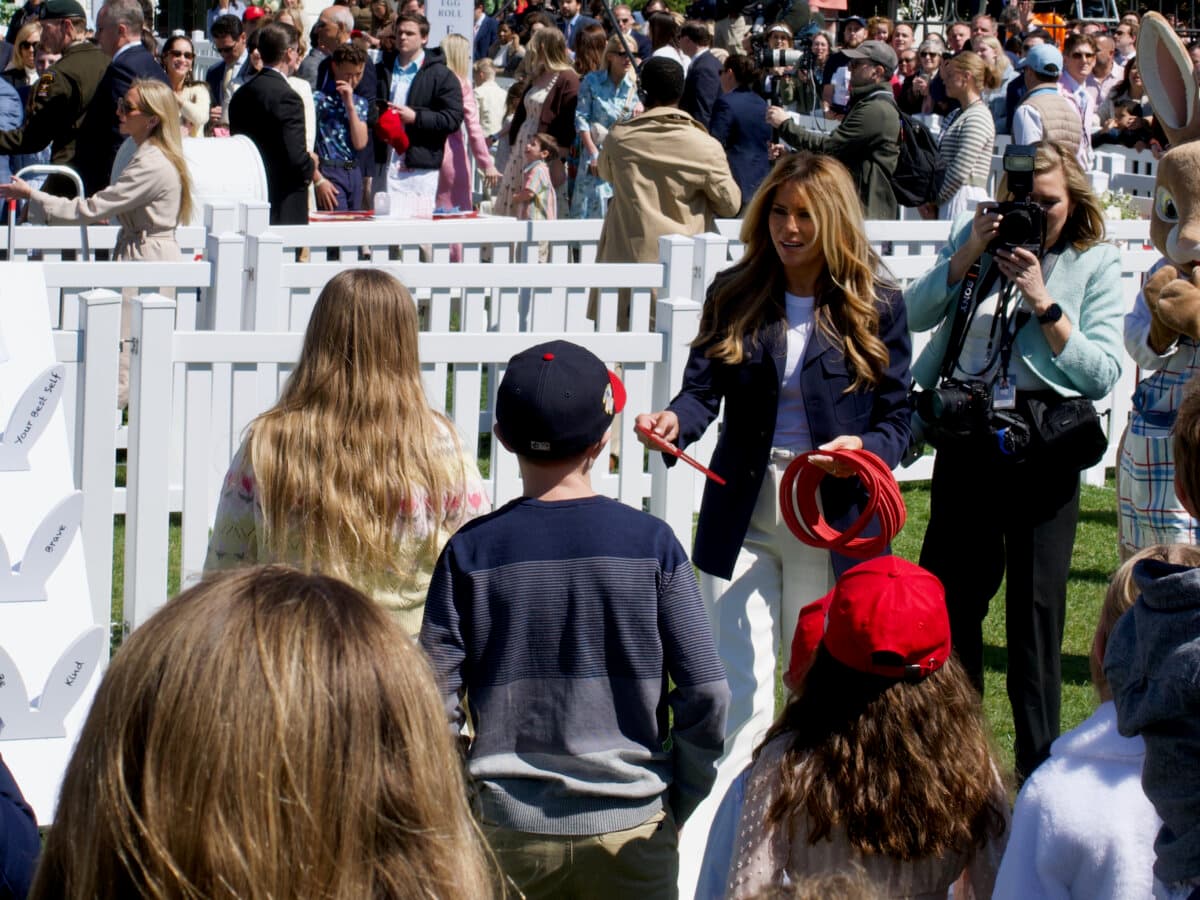 First Lady Melania Trump participates in a Be Best ring toss game at the White House Easter Egg Roll in Washington on April 6, 2026. (Travis Gillmore/The Epoch Times)