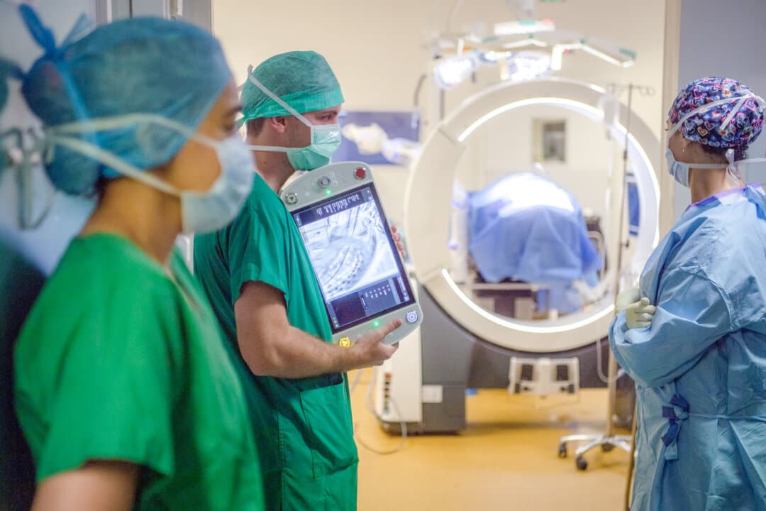 A surgical team uses a live medical imagery system to secure the work on the spine of a patient at a hospital in Angers, France, on June 10, 2021. (Loic Venance/AFP via Getty Images)