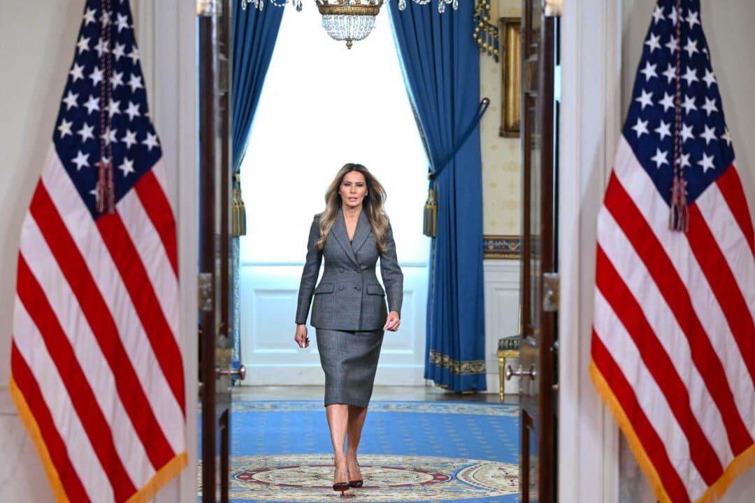 First Lady Melania Trump walks from the Blue Room as she arrives to speak in the Cross Hall of the White House in Washington on April 9, 2026. (Mandel Ngan/AFP via Getty Images)