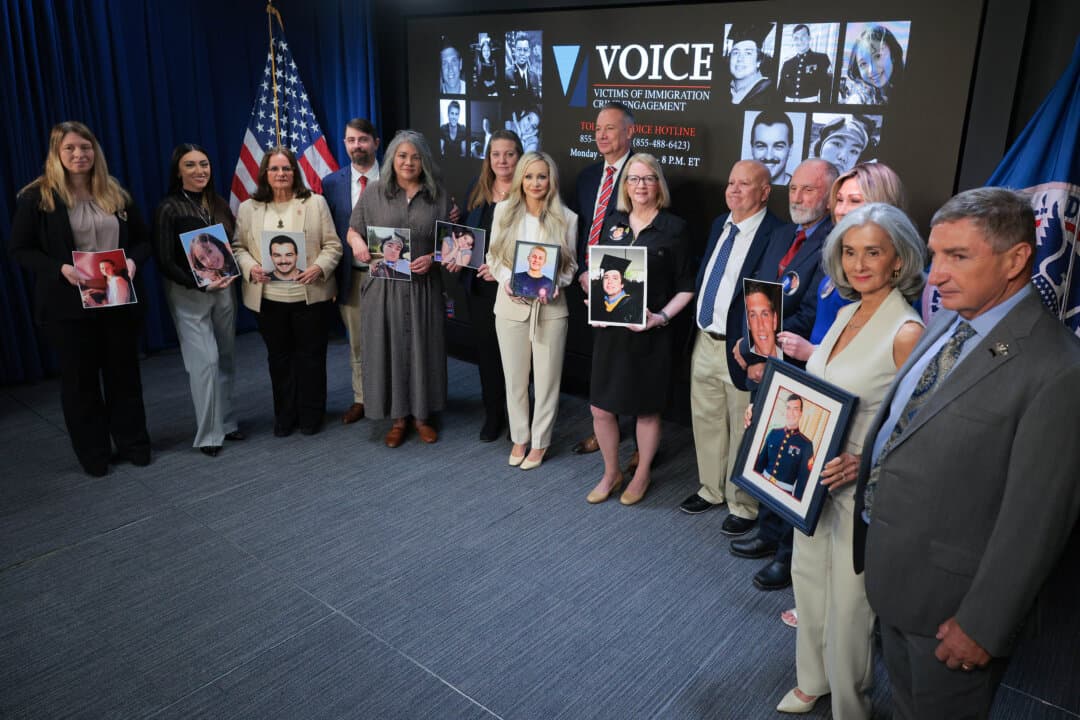 U.S. Immigration and Customs Enforcement (ICE) Director Todd Lyons (C) poses for photographs with family members of victims of crime by undocumented immigrants following an event at the agency's headquarters in Washington on April 9, 2026. Lyons marked the one-year anniversary of the relaunch of the Victims of Immigration Crime Engagement Office, which ICE describes as a “comprehensive support system that provides assistance and resources to individuals victimized by criminal illegal aliens.” (Chip Somodevilla/Getty Images)