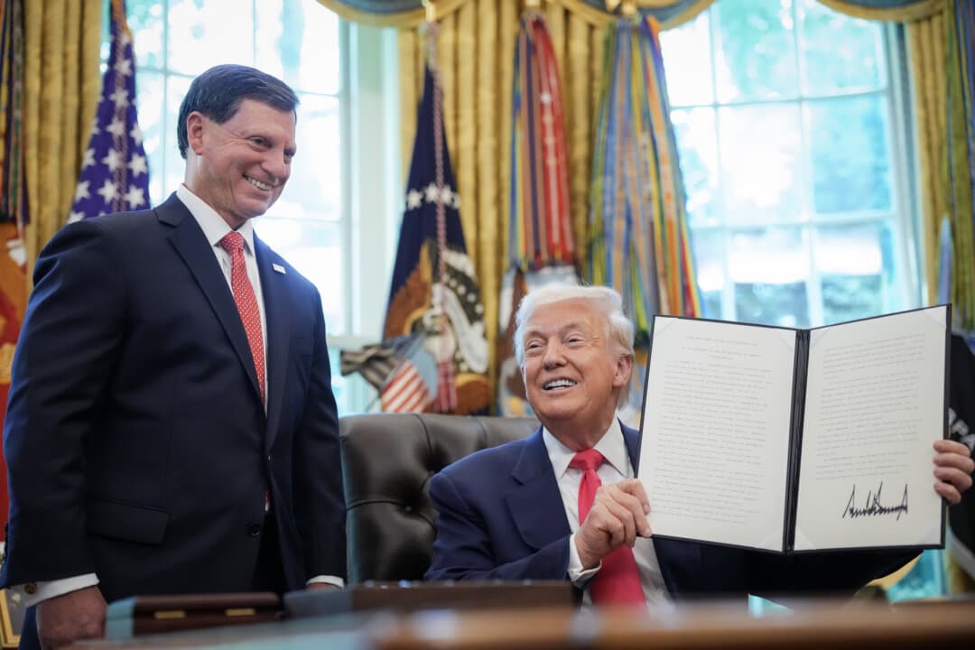 President Donald Trump holds up a proclamation with his signature, with Frank Bisignano (L), administrator of the Social Security Administration, in the Oval Office on Aug. 14, 2025. (Andrew Harnik/Getty Images)