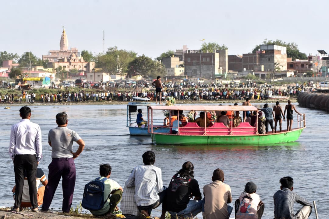 Rescuers search the site where a boat carrying pilgrims capsized in the Yamuna river in Vrindavan, India, on April 10, 2026. (AP Photo)