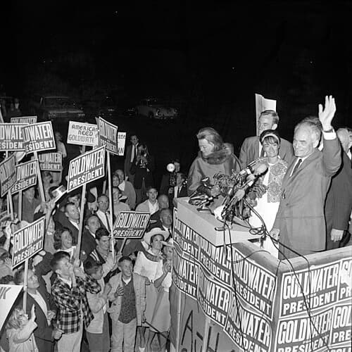 Barry Goldwater with family waving to crowd at Lockheed Air Terminal during presidential campaign in Burbank, Calif. (Los Angeles Times/<a href="https://commons.wikimedia.org/wiki/File:Barry_Goldwater_with_family_waving_to_crowd_at_Lockheed_Air_Terminal.jpg">CC BY-SA 4.0</a>)