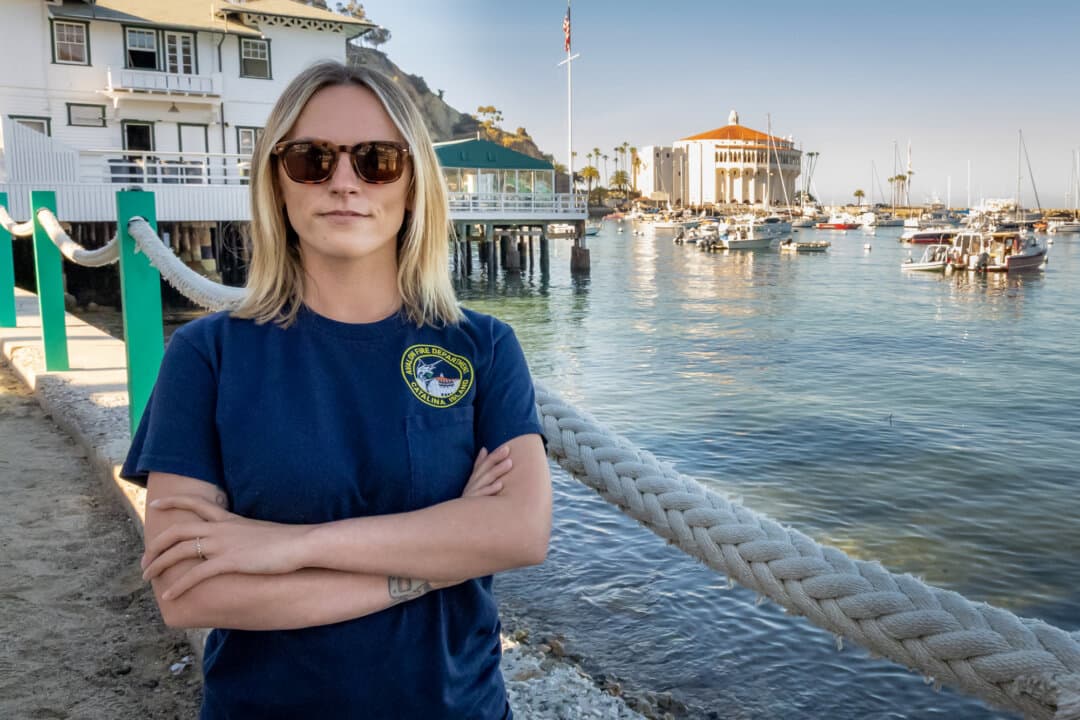 Bre Bussard stands near the beaches of Avalon, Calif., on March 18, 2026. Bussard, a small business owner who runs history tours in Avalon, said the eradication plan is “just wrong,” and that there’s not enough scientific evidence to justify killing all the deer. (John Fredricks/The Epoch Times)