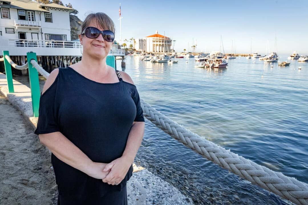 Wendy Hernandez stands near the beaches of Avalon, Calif., on March 18, 2026. Hernandez, an islander and founding member of the Coalition to Save Catalina Island Deer, thinks William Wrigley Jr.’s vision for the island is lost. (John Fredricks/The Epoch Times)