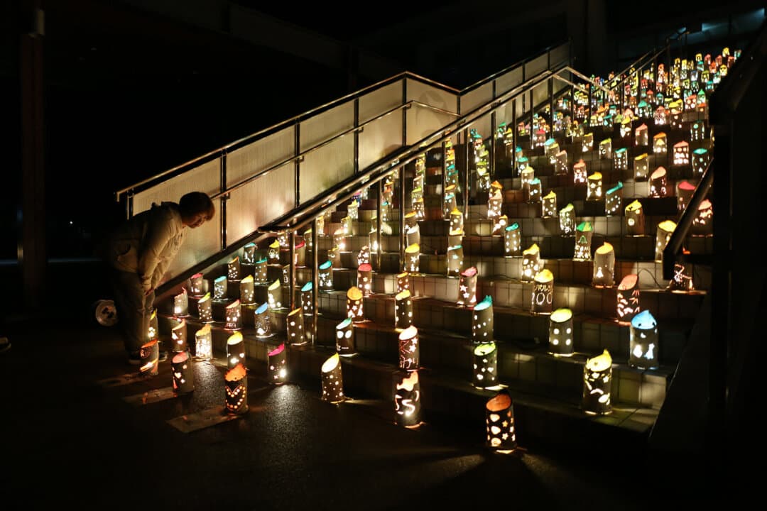 A woman looks at lights set up to commemorate victims of the 2016 Kumamoto earthquake, at Nishihara Village Sports Park in Kumamoto Prefecture, Japan, on April 16, 2026. (Jiji Press/AFP via Getty Images)
