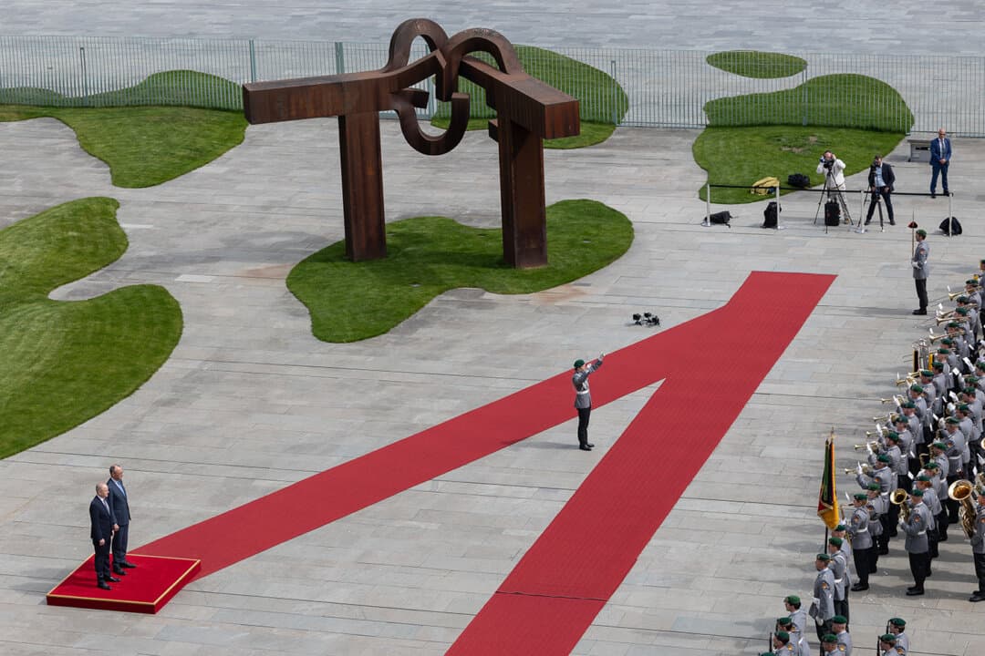 German Chancellor Friedrich Merz (R) and Irish Taoiseach Micheal Martin review a guard of honor before talks at the chancellery in Berlin on April 16, 2026. (Maja Hitij/Getty Images)
