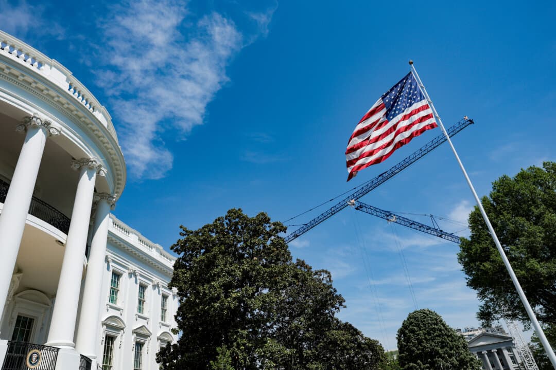 Construction cranes are seen behind a flagpole on the South Lawn of the White House on April 16, 2026. (Anna Moneymaker/Getty Images)