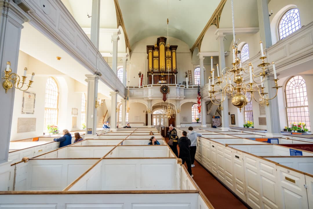 (Top) Charles White, an Army veteran and history buff, at the Old North Church in Boston on April 8, 2026. (Bottom) The Old North Church in Boston on April 8, 2026. (Samira Bouaou/The Epoch Times)