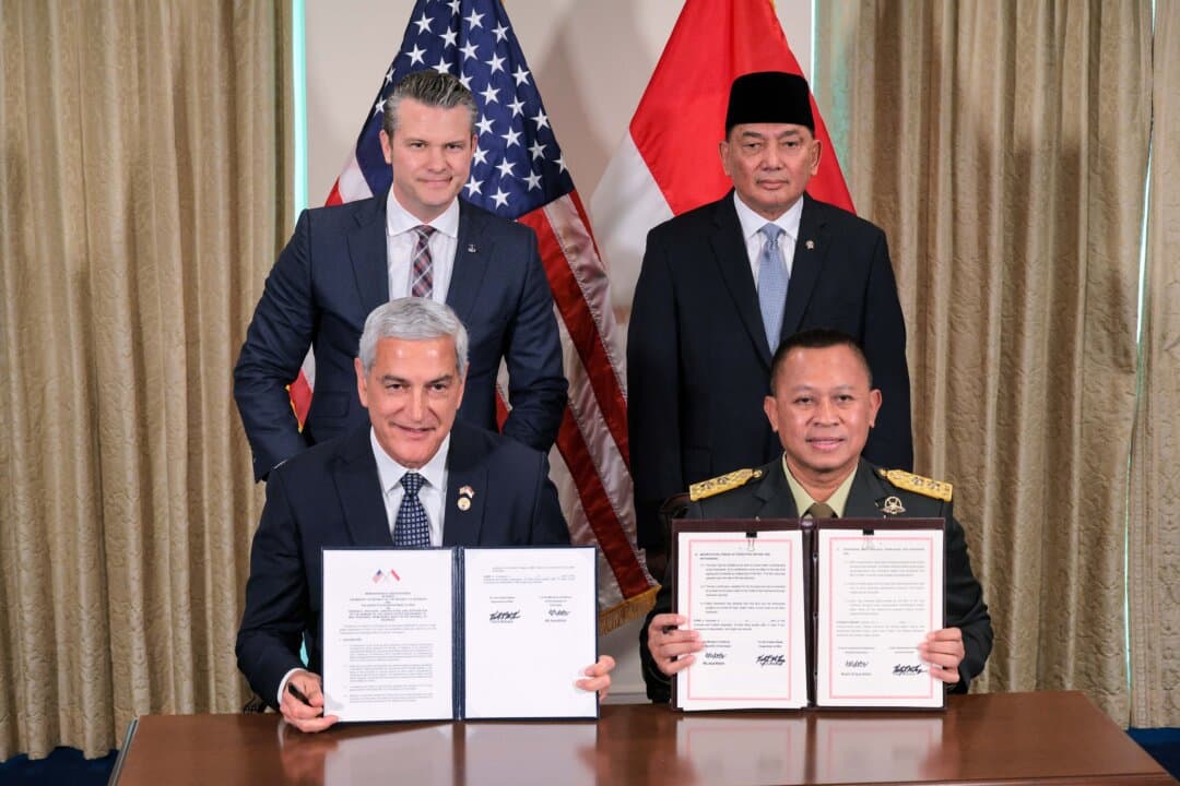 U.S. Secretary of War Pete Hegseth (L) and Indonesian Minister of Defense Sjafrie Sjamsoeddin pose for photographs with U.S. Air Force Major General Kelly McKeague and Indonesian Major General Agus Widodo (R) after signing a memorandum of understanding at the Pentagon in Arlington, Va., on April 13, 2026. Emphasizing that both countries share a “peace through strength” approach, Hegseth said that the United States and Indonesia are increasing military cooperation and signed the MOU to investigate, locate, and recover remains of American service members from World War II. (Chip Somodevilla/Getty Images)