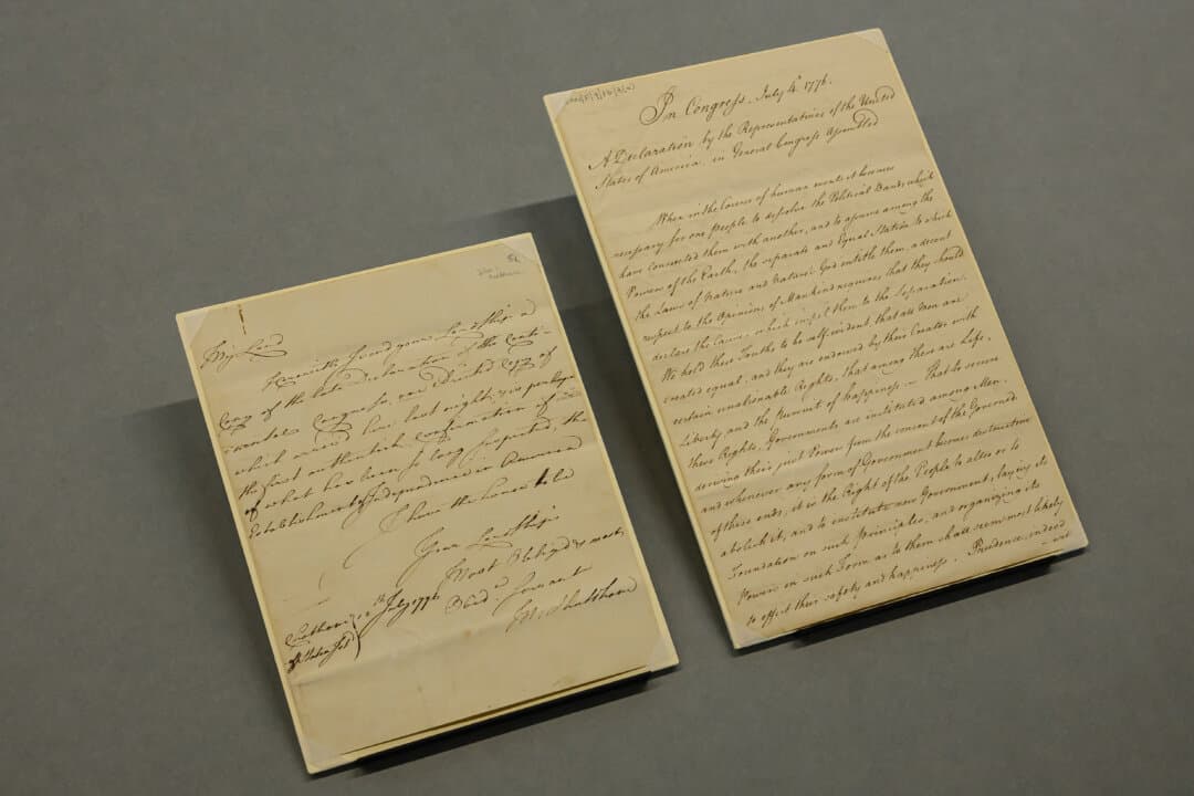 A handwritten manuscript made between July 5 and July 10, 1776, the earliest report of American independence to reach Britain, is displayed with an accompanying letter (L), during an exhibition preview at the National Maritime Museum in London on April 20, 2026. The manuscript, sent by Vice Admiral Molyneux Shuldham to John Montagu, 4th Earl of Sandwich, will go on display to the public on June 15 during a free temporary exhibition marking 250 years of American Independence. In his letter, Shuldham, who was stationed in North America at the time, transcribed a Dunlap Broadside printing of the Declaration of Independence, produced on July 4, 1776, and sent it to the Earl of Sandwich. According to the museum, it is possible “this transcription was the very first text of the Declaration to reach British shores.” (Leon Neal/Getty Images)