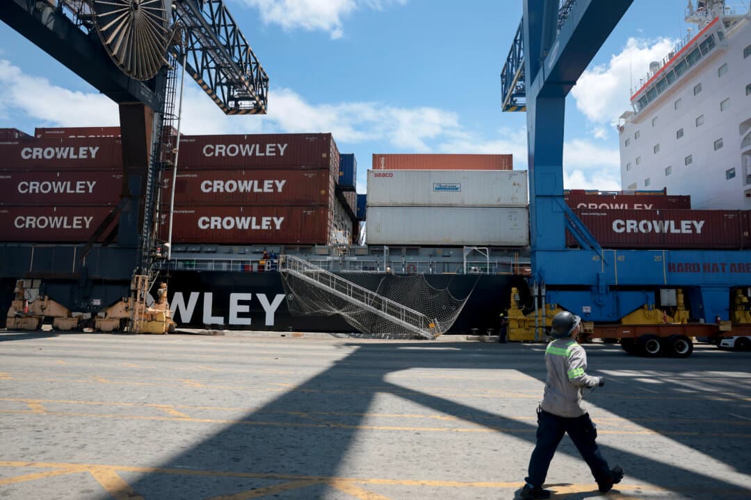 Dock workers offload containers from a ship at Port Everglades in Fort Lauderdale, Fla., on April 20, 2026. The U.S. government has launched an online portal for companies to claim refunds for tariffs invalidated by the Supreme Court earlier this year. In a 6–3 decision, the court ruled that President Donald Trump overstepped Congress’s tax-setting authority by imposing new import tax rates on products from nearly every country, citing the U.S. trade deficit as a national emergency. (Joe Raedle/Getty Images)