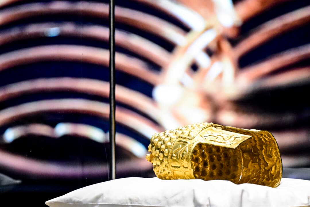 The ancient Cotofenesti helmet and two Dacian gold bracelets are on display at the National Museum of History of Romania in Bucharest on April 21, 2026. The artifacts, shown together for the first time since their repatriation, are part of a national campaign to bring Romania's most significant ancient treasures to the public nationwide. (Daniel Mihailescu/AFP via Getty Images)