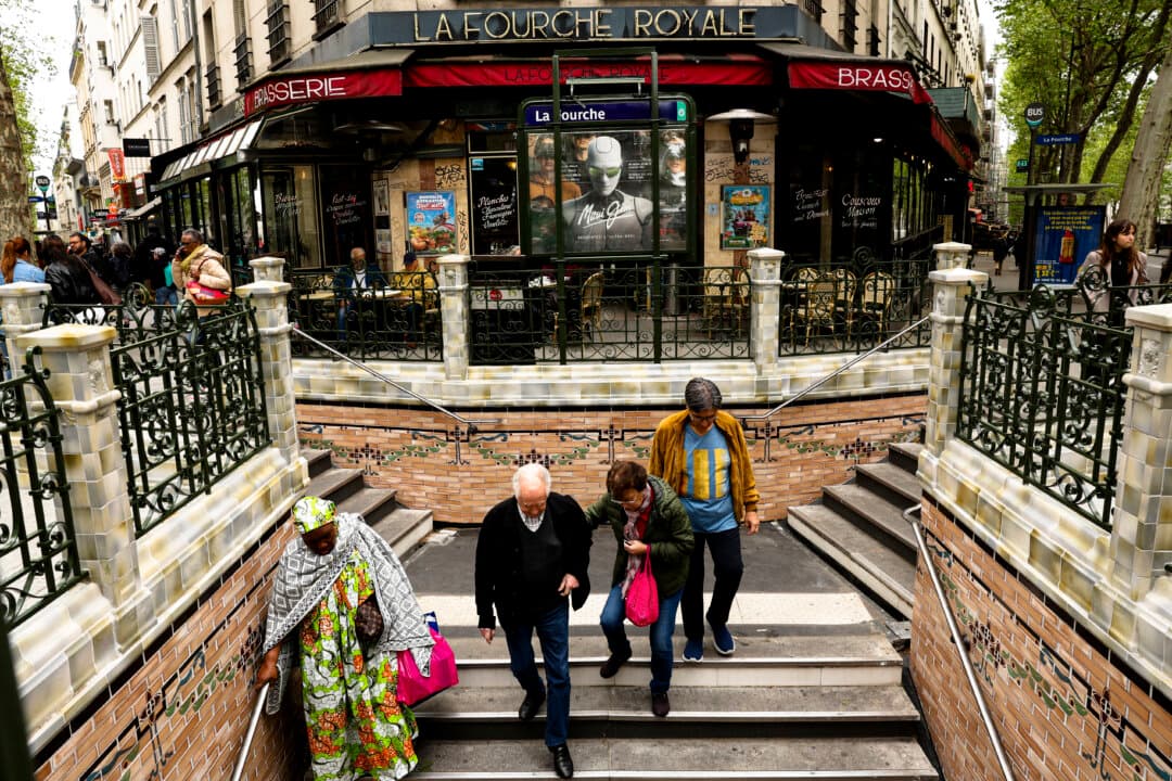 Commuters enter the newly renovated public transport metro station La Fourche in Paris on April 21, 2026. The station, renovated to match its original design, was damaged in a bus accident in 1964. (Charlotte Siemon/AFP via Getty Images)