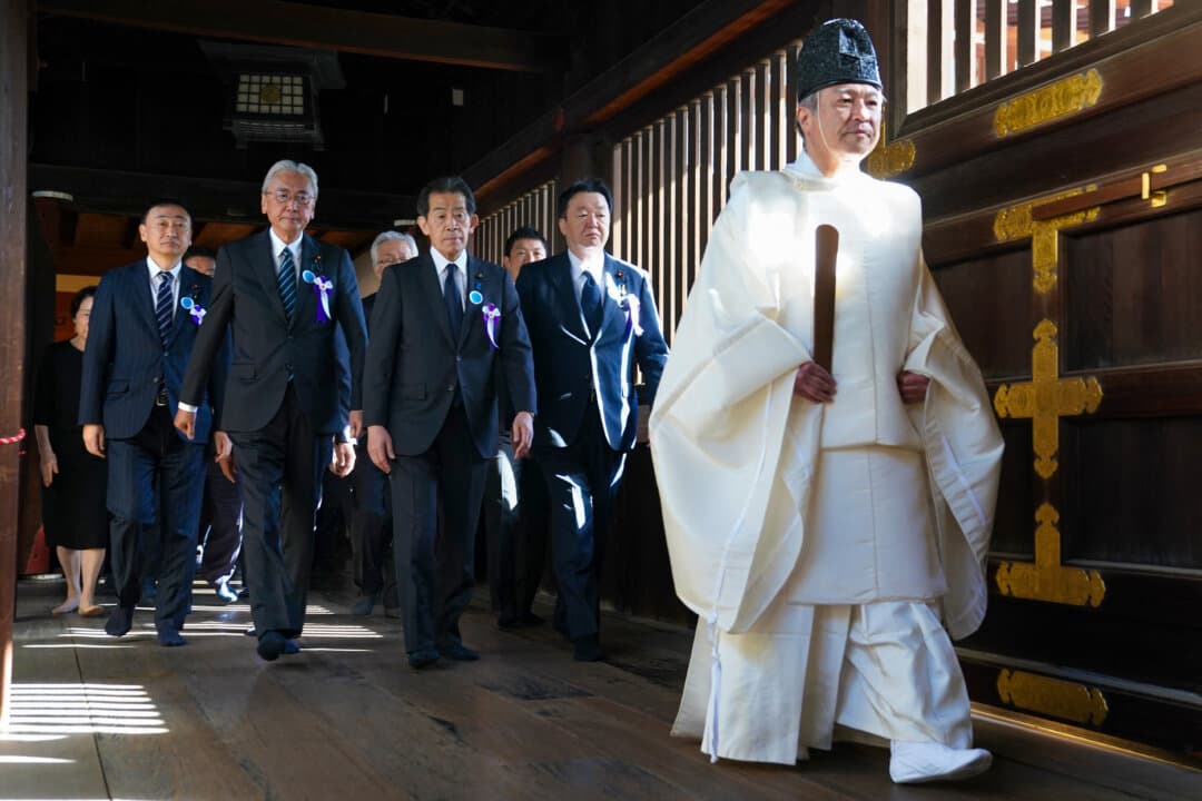 A Shinto priest leads parliament members to pray for the war dead at Yasukuni Shrine in Tokyo as part of the shrine's three-day spring festival, on April 22, 2026. (Kazuhiro Nogi/AFP via Getty Images)