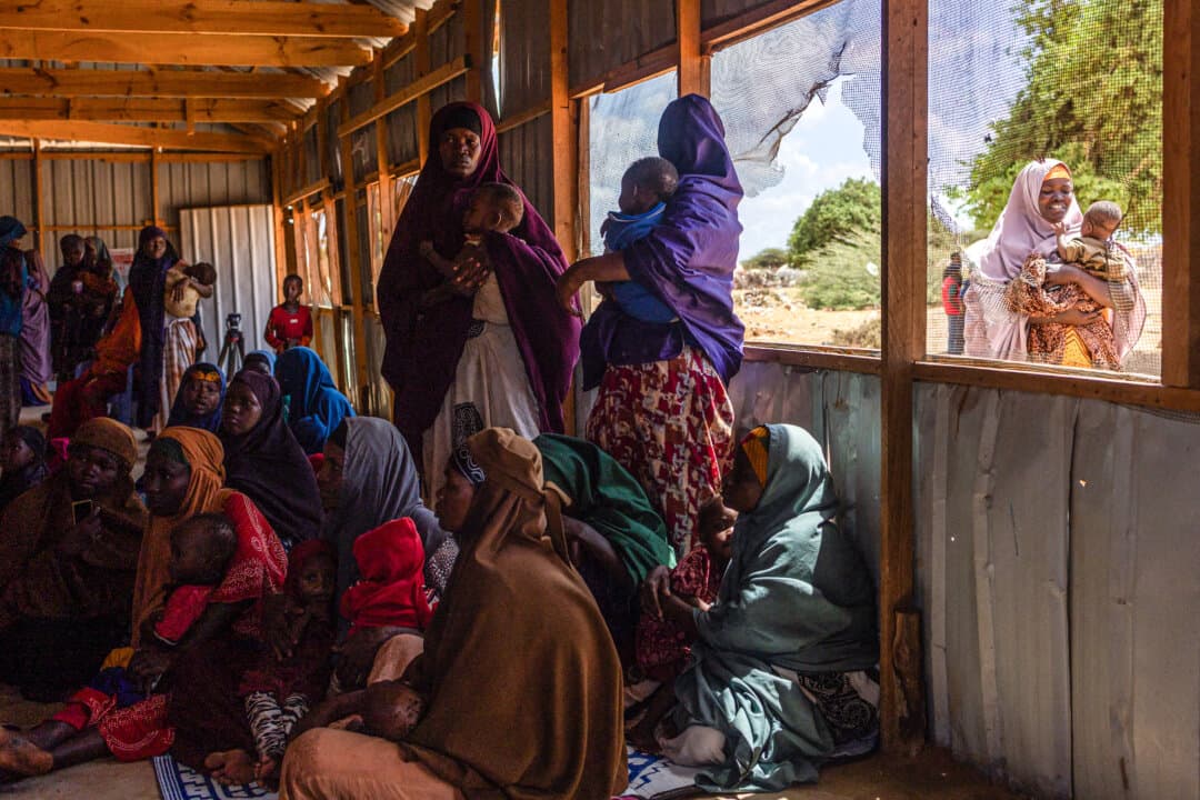 Newly displaced Somali women register as their children are screened for malnutrition at an internally displaced persons camp on the outskirts of Kismayo, Somalia, on April 22, 2026. Millions of people are facing the repercussions of a severe drought after three consecutive failed rainy seasons. (Simon Maina/AFP via Getty Images)