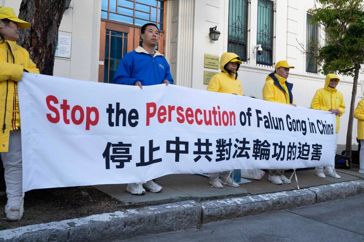 Falun Gong practitioners hold a banner in front of the San Francisco Chinese Consulate on April 24, 2026, to commemorate the 27th anniversary of the April 25, 1999, peaceful appeal in Beijing. (Gary Wang/The Epoch Times)