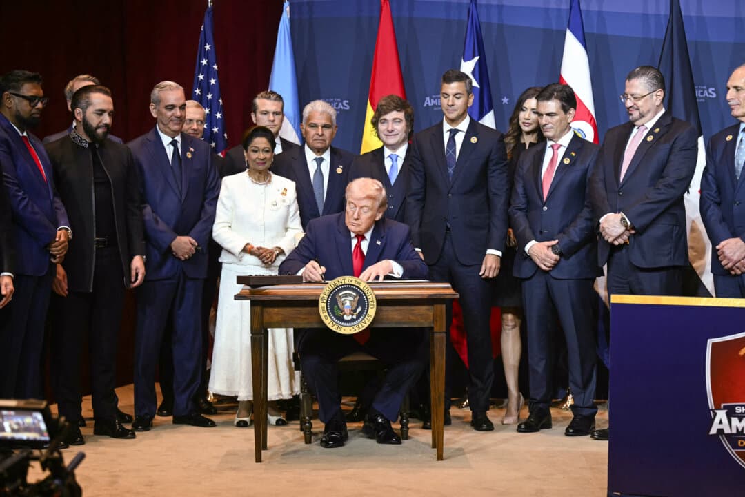 U.S. President Donald Trump signs a proclamation at the Shield of the Americas Summit at Trump National Doral in Miami on March 7, 2026. Trump said the United States is “looking forward to the great change” coming to Cuba following what he called a