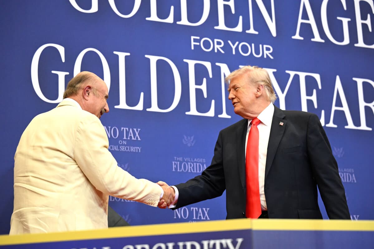 President Donald Trump (R) shakes hands with television personality Phil McGraw at The Villages Charter School in The Villages, Fla., on May 1, 2026. (Roberto Schmidt/Getty Images)