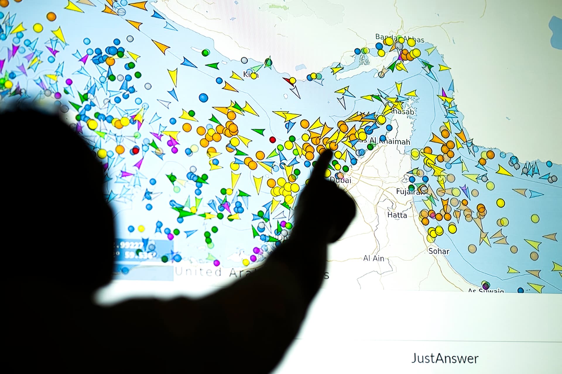 A photo illustration taken in Nicosia, Cyprus, on May 4, 2026, shows a person in front of a large screen displaying vessel movements in the Strait of Hormuz on a ship-tracking website. (AFP/Getty Images)