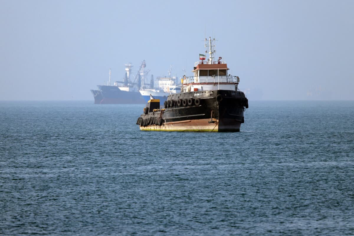 The Iran-flagged tugboat Basim sails near a ship anchored in the Strait of Hormuz off Bandar Abbas in southern Iran, in this picture obtained from Iran's ISNA news agency on May 4, 2026. (Amirhossein Khorgooei/ISNA/AFP via Getty Images)