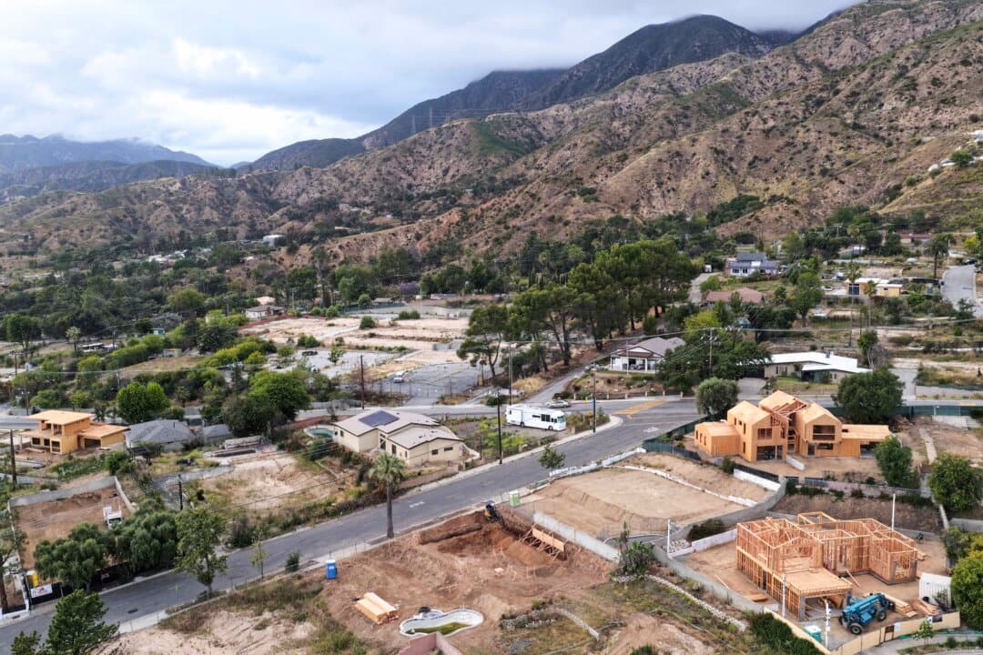 Homes being rebuilt amid cleared lots where homes were destroyed by the Eaton Fire in Altadena, Calif., on May 4, 2026. California initiated legal action against insurer State Farm on May 4, accusing them of delaying and underpaying home insurance claims by survivors of the 2025 Los Angeles wildfires. The Eaton Fire ignited on Jan. 7, 2025, killing 19 people and destroying more than 9,000 structures, most of them homes in Altadena. (Mario Tama/Getty Images)