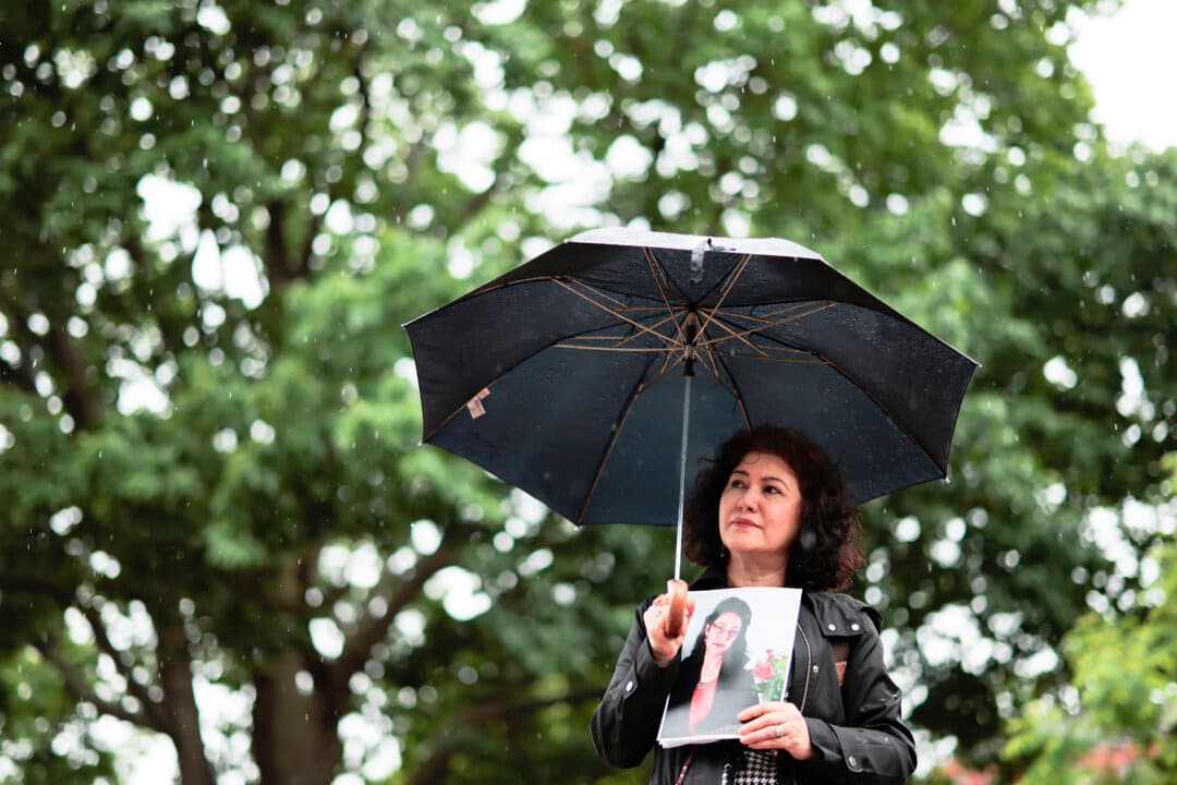 Rushan Abbas holds a photo of her sister, Uyghur doctor Gulshan Abbas, who is detained in China, during the “No Deals Without Freedom” protest at Lafayette Park in Washington on May 11, 2026. Held ahead of President Donald Trump’s visit to China later this week, the protest called on Trump to use his meeting with Chinese President Xi Jinping to advocate for the release of Jimmy Lai and others believed to be unjustly detained across China. (Heather Diehl/Getty Images)