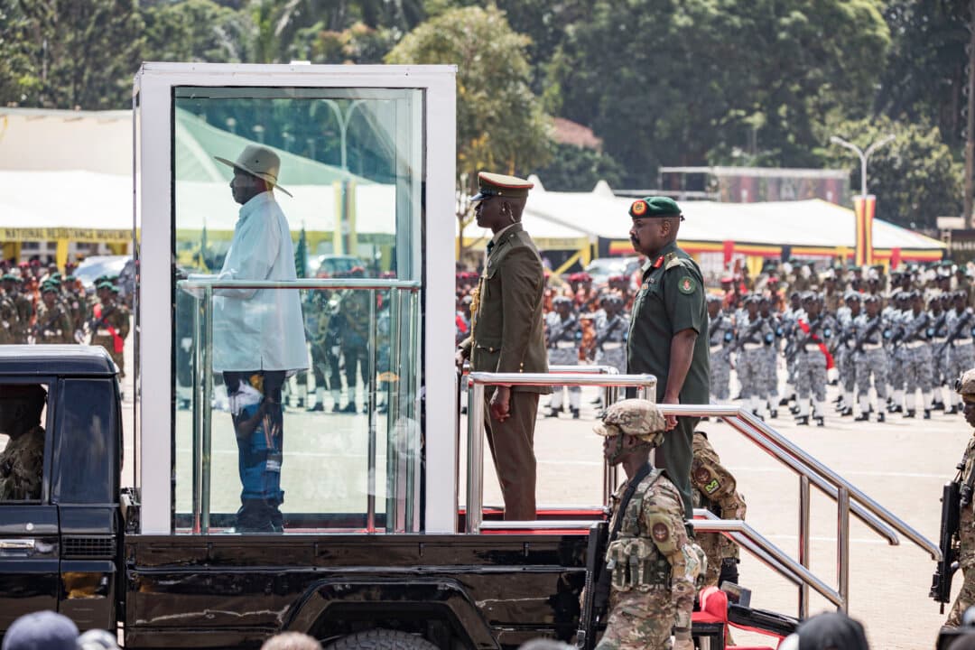 Uganda's President Yoweri Museveni (L on vehicle), recently re-elected for a record seventh term, inspects a military parade during his inauguration ceremony while his son and Chief of Defense Forces Muhoozi Kainerugaba (R on vehicle) stands behind at Kololo Ceremonial grounds in Kampala, Uganda on May 12, 2026. (Badru Katumba/AFP via Getty Images)
