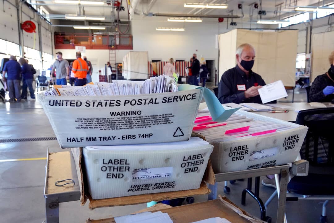 Election officials count absentee ballots at a polling place located in the Beloit fire station near Beloit, Wis., on Nov. 3, 2020. (Scott Olson/Getty Images)