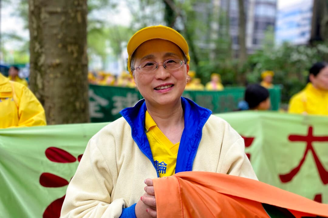 April Zhang, 56, suffered from asthma long term before taking up Falun Gong. She joined the parade in Manhattan to celebrate World Falun Dafa Day, May 13, 2026. (Nicholas Zifcak/The Epoch Times)