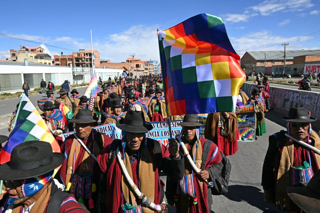 Indigenous people from the “Ponchos Rojos” union march from El Alto to La Paz, Bolivia, during a protest against the government of Bolivian President Rodrigo Paz, on May 13, 2026. For the past two weeks, workers, farmers, teachers, indigenous groups, and transport workers have pressured the government over wage increases, economic stability, and opposition to privatization. (Paizar Raldes/AFP via Getty Images)