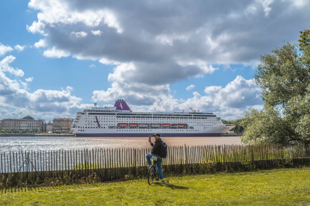 The cruise ship Ambition operated by Ambassador Cruise Line remains immobilized in the port of Bordeaux after several cases of acute gastrointestinal illness were reported among passengers and crew members in Bordeaux, France, on May 13, 2026. French health authorities confined more than 1,700 people on board while medical teams carried out sanitary inspections and laboratory analyses to determine the origin of the outbreak. (David Sepeau/Hans Lucas/AFP via Getty Images)
