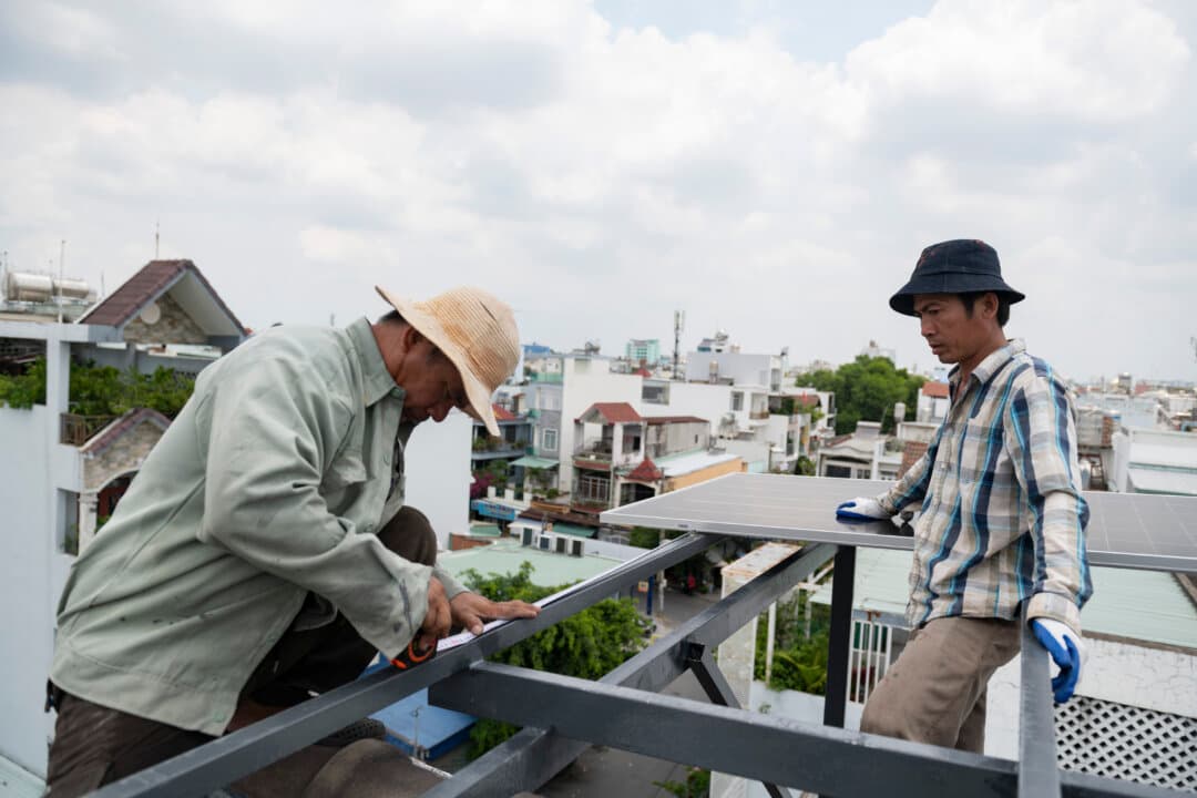 Workers install rooftop solar panels on a house in Ho Chi Minh City, Vietnam, on May 13, 2026. Vietnam is expanding rooftop solar adoption as part of a broader push toward renewable energy and long-term energy security. (Thanh Hue/Getty Images)
