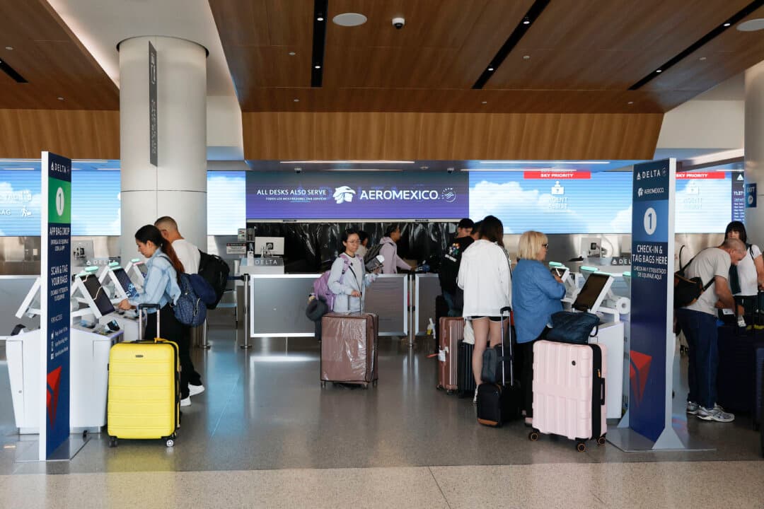 Passengers check in for flights at Los Angeles International Airport in Los Angeles on May 13, 2026. Rising jet fuel prices tied to the war in Iran and disruptions in the Strait of Hormuz are driving up airline operating costs, prompting carriers to raise ticket prices and cut some routes. (Justin Sullivan/Getty Images)