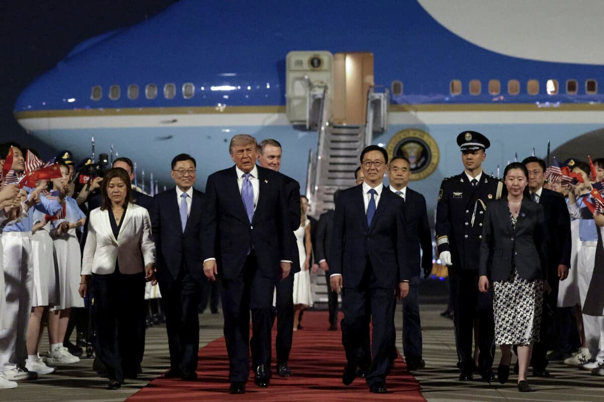 U.S. President Donald Trump (C) is joined by Chinese officials as he arrives at Beijing Capital International Airport on May 13, 2026. (Alex Wong/Getty Images)