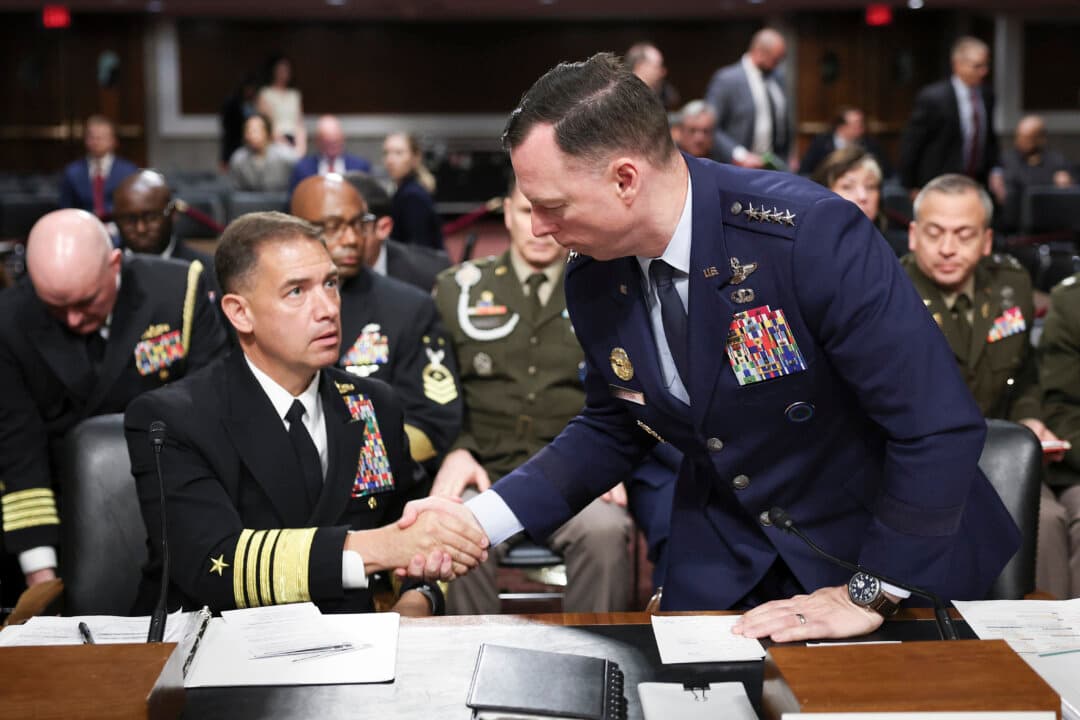 Commander of U.S. Africa Command Air Force Gen. Dagvin Anderson (R) shakes hands with Commander of U.S. Central Command Navy Adm. Brad Cooper as they conclude their testimony before the Senate Armed Services Committee in the Dirksen Senate Office Building on Capitol Hill on May 14, 2026. The full committee heard testimony on defense spending for fiscal year 2027. (Win McNamee/Getty Images)