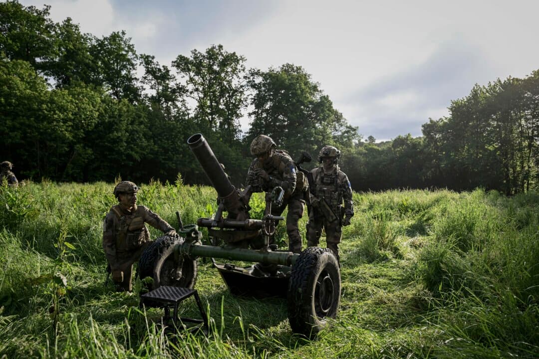 A French Foreign Legion paratrooper from the 2nd Foreign Parachute Regiment adjusts the rifled mortar as a comrade consults firing data during an exercise near La Souterraine, central France, on May 14, 2026. The exercise, running from May 11 to 20 across Nouvelle-Aquitaine and Centre-Val de Loire, tests air and ground components central to France's contribution to NATO rapid-reaction forces. (Philippe Lopez/AFP via Getty Images)