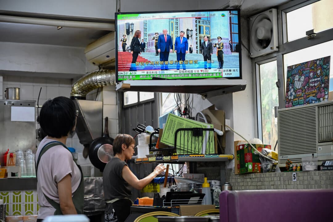 A television news program at a restaurant in Hong Kong on May 14, 2026, shows the meeting of President Donald Trump and Chinese leader Xi Jinping in Beijing. (Peter Parks/AFP via Getty Images)