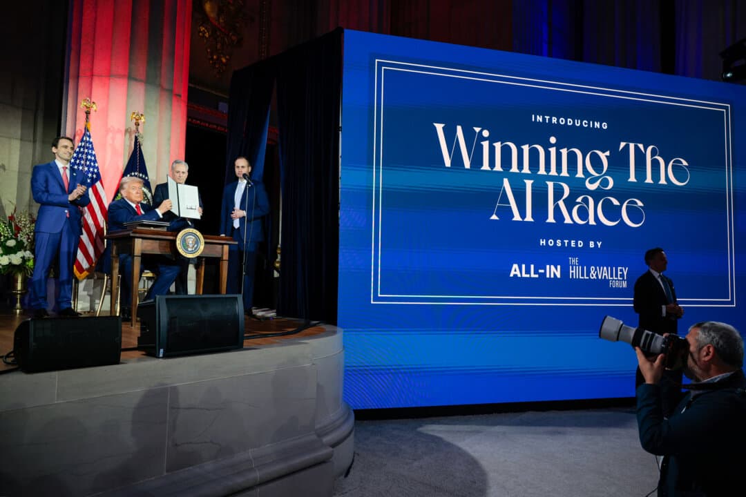 President Donald Trump displays a signed executive order during the "Winning the AI Race” summit in Washington on July 23, 2025. (Chip Somodevilla/Getty Images)