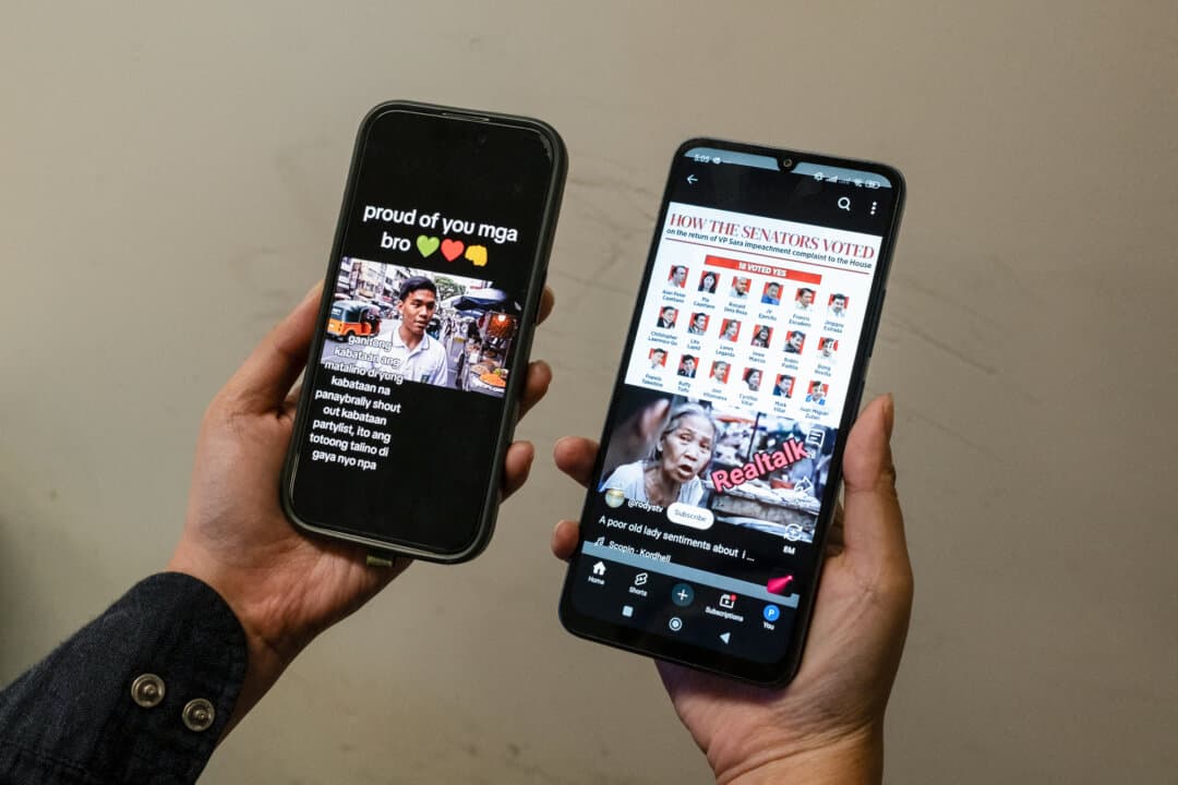 A person holds mobile phones displaying viral AI-generated videos of people sharing views on the impeachment of Philippine Vice President Sara Duterte, in Hong Kong, on June 20, 2025. Days after the Philippine Senate declined to launch the impeachment trial, the videos arguing for and against the move went viral. (Yan Zhao/AFP via Getty Images)