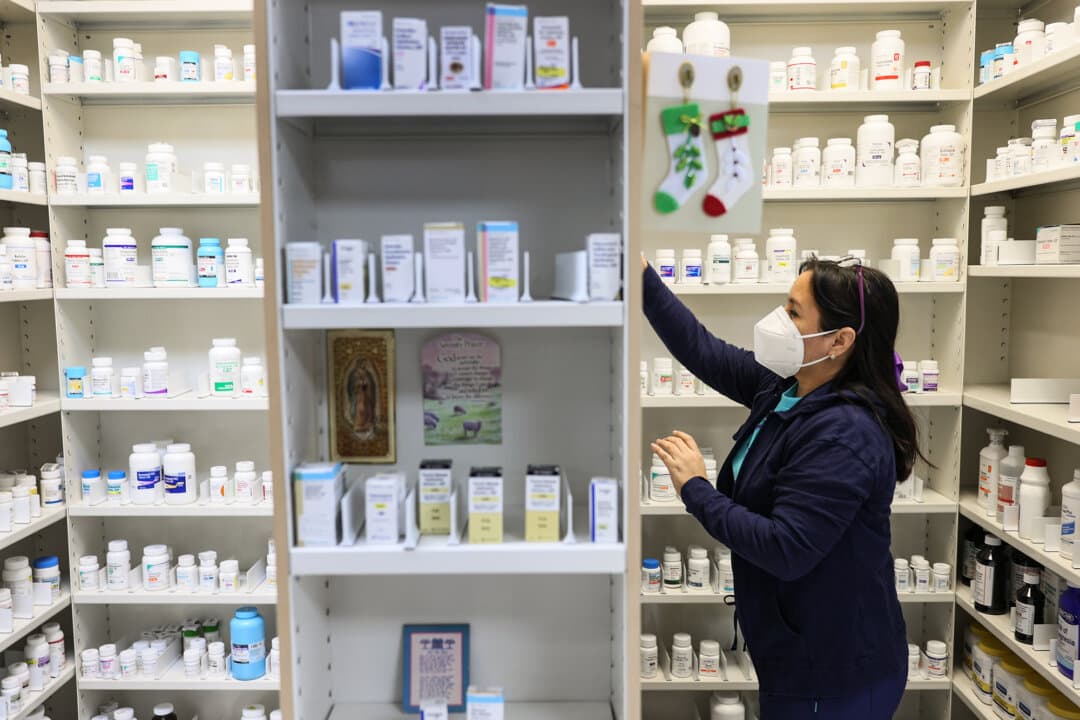 A pharmacy technician works in the P & P Pharmacy in Miami on Dec. 22, 2020. A group of bipartisan lawmakers is pushing for the adoption of the ETHIC Act, which aims to eliminate the use of duplicative, overlapping patents. (Joe Raedle/Getty Images)