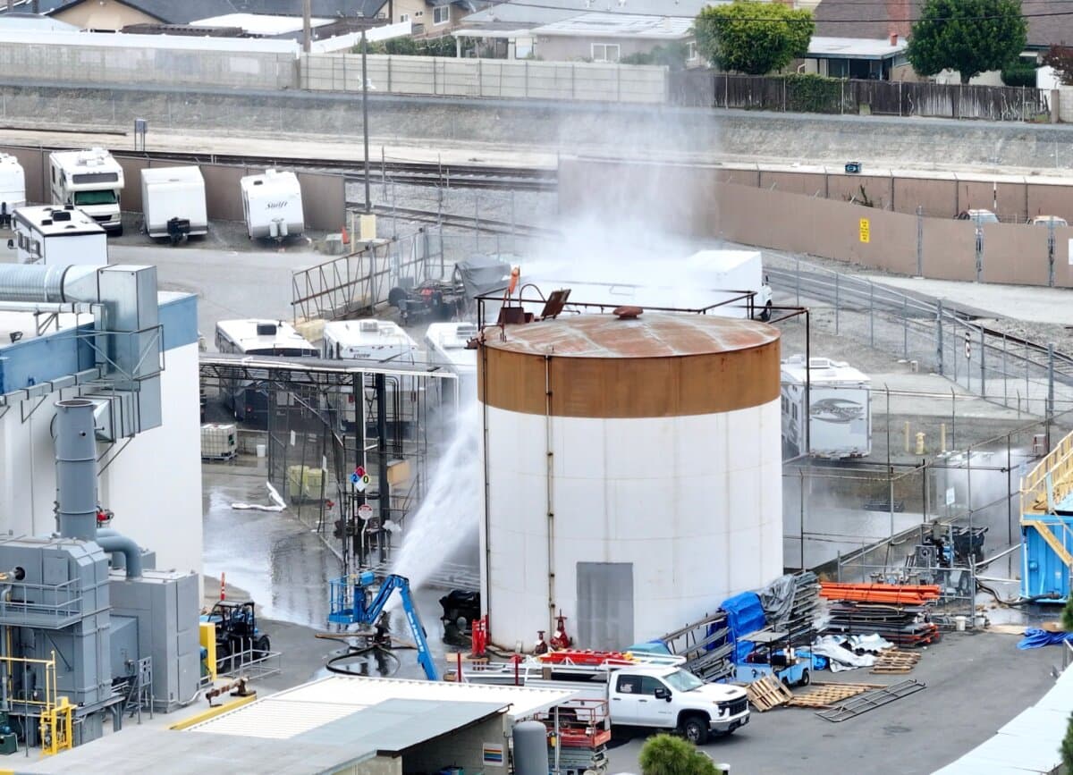 Water is sprayed on a tank that overheated at an aerospace plant in Garden Grove, Calif., on May 22, 2026. (Jeff Gritchen/The Orange County Register via AP)