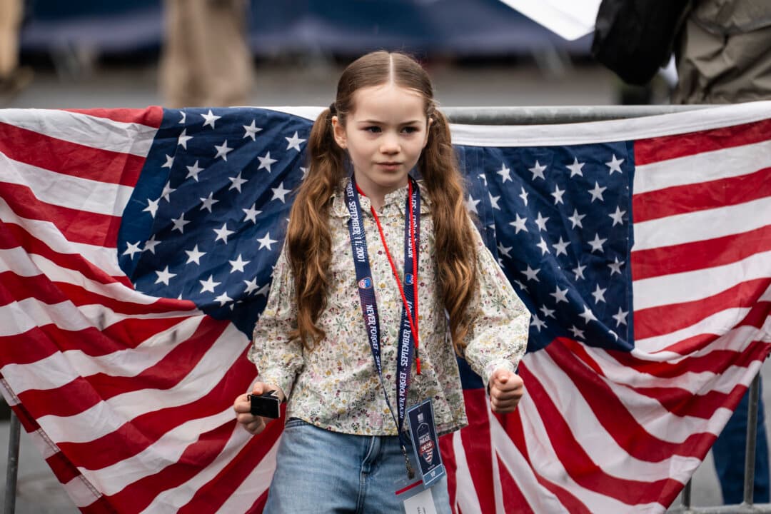 A girl watches the National Memorial Day parade in Washington on May 25, 2026. (Madalina Kilroy/The Epoch Times)